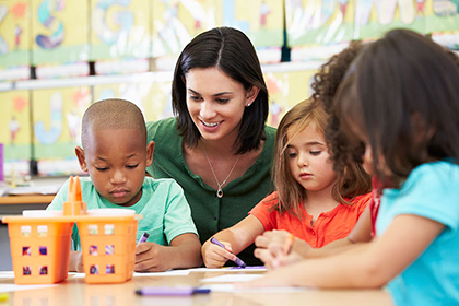 A childcare provider sitting with children