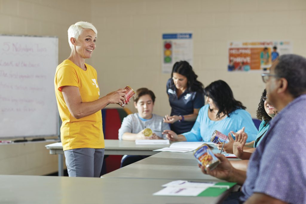 Photo of a woman instructing in a YMCA classroom