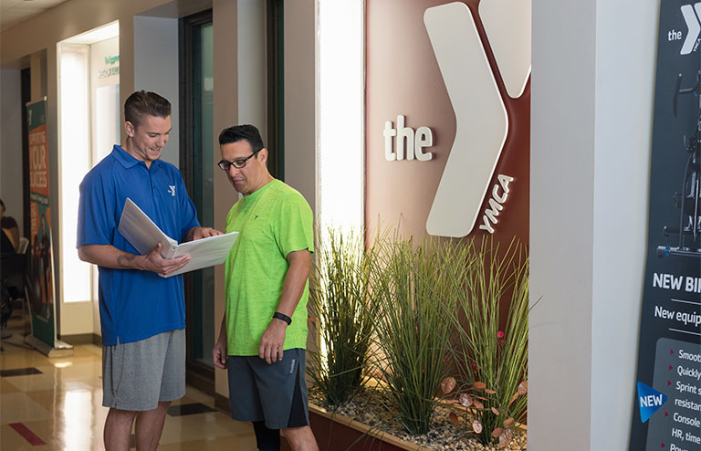 Photo of a YMCA staff member discussing options with a member