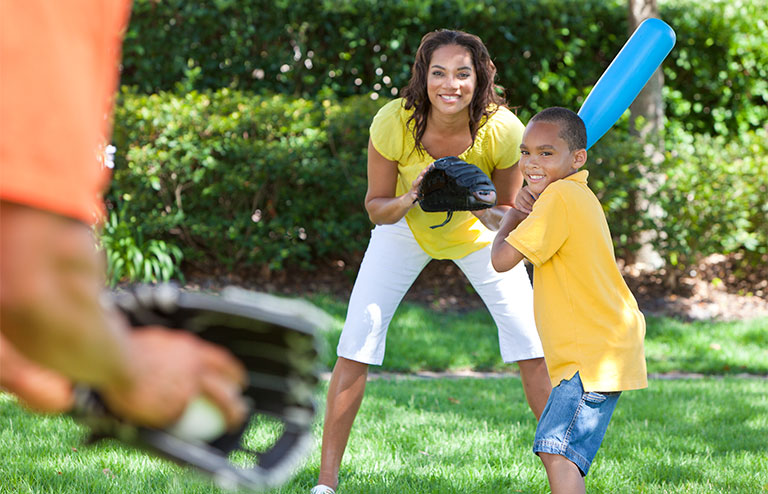 Photo of a family playing baseball together