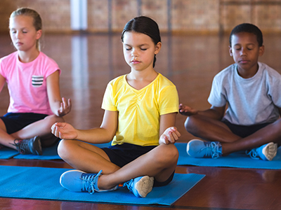 Photo of YMCA youth members practicing yoga