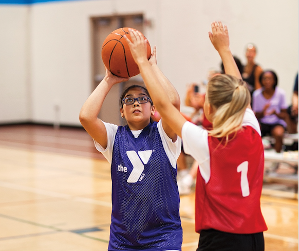 Photo of two YMCA kids playing basketball