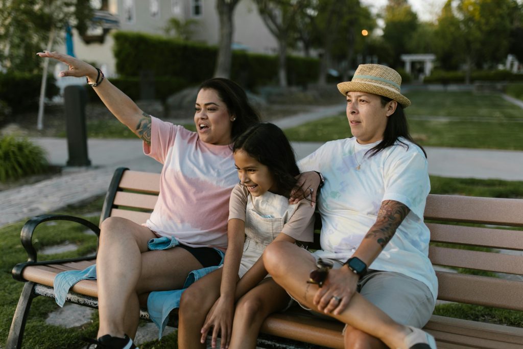 Photo of a family sitting on a park bench