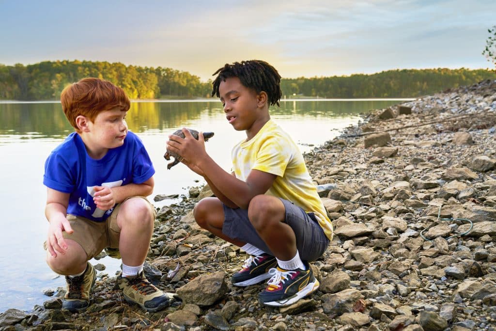 Photo of kids playing by water.