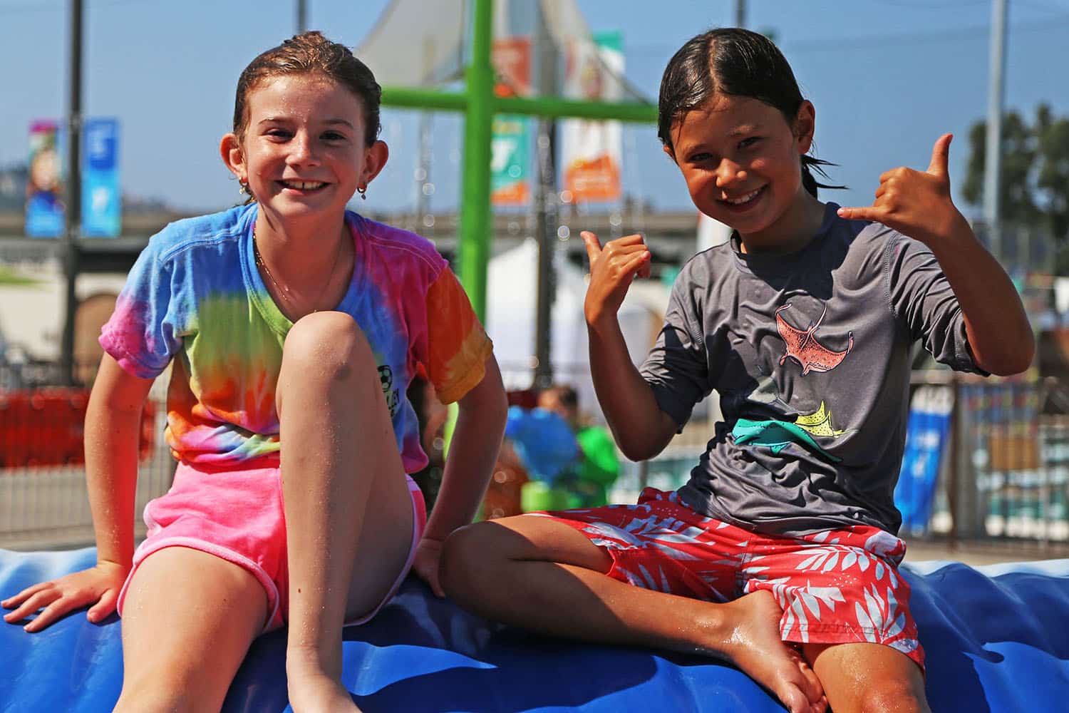 two kids laughing at splash pad