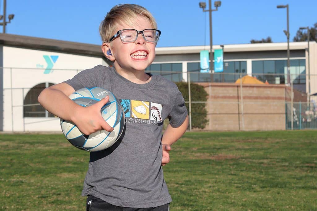 child running with ball